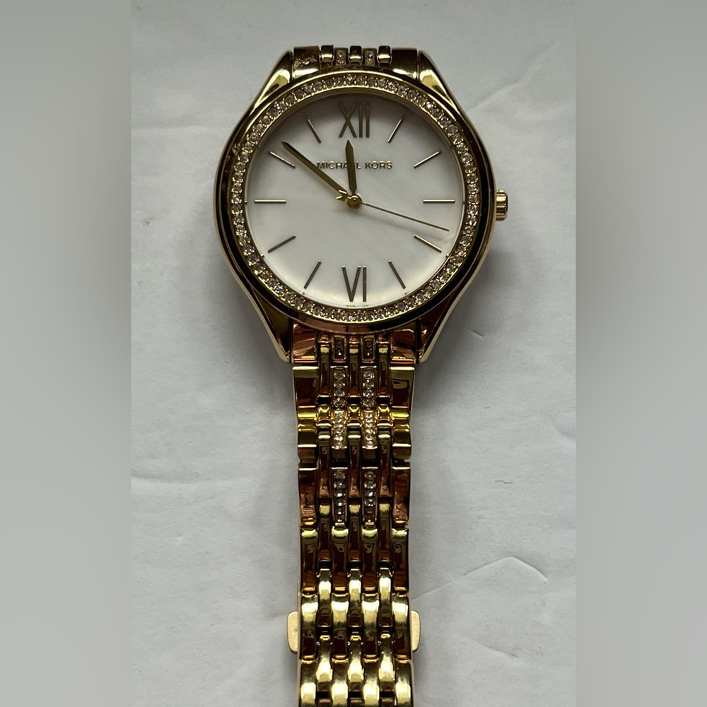Michael Kor’s Gold-Tone watch with rhinestone embellishment.